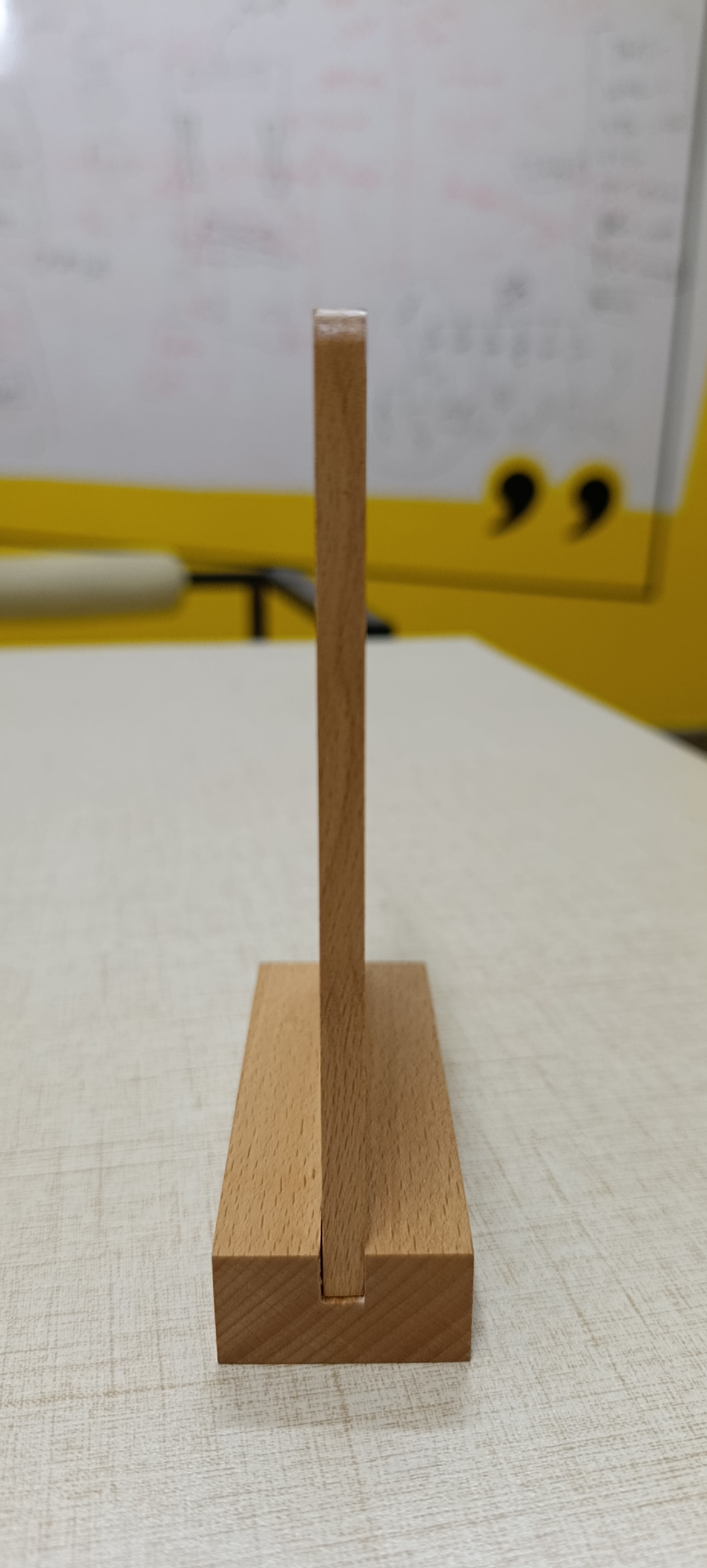 Side profile of the Review+ beechwood standee showing the slotted solid wooden base