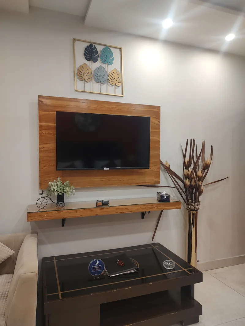 Premier Inn Grand GolTap on a guest-room coffee table beneath a television