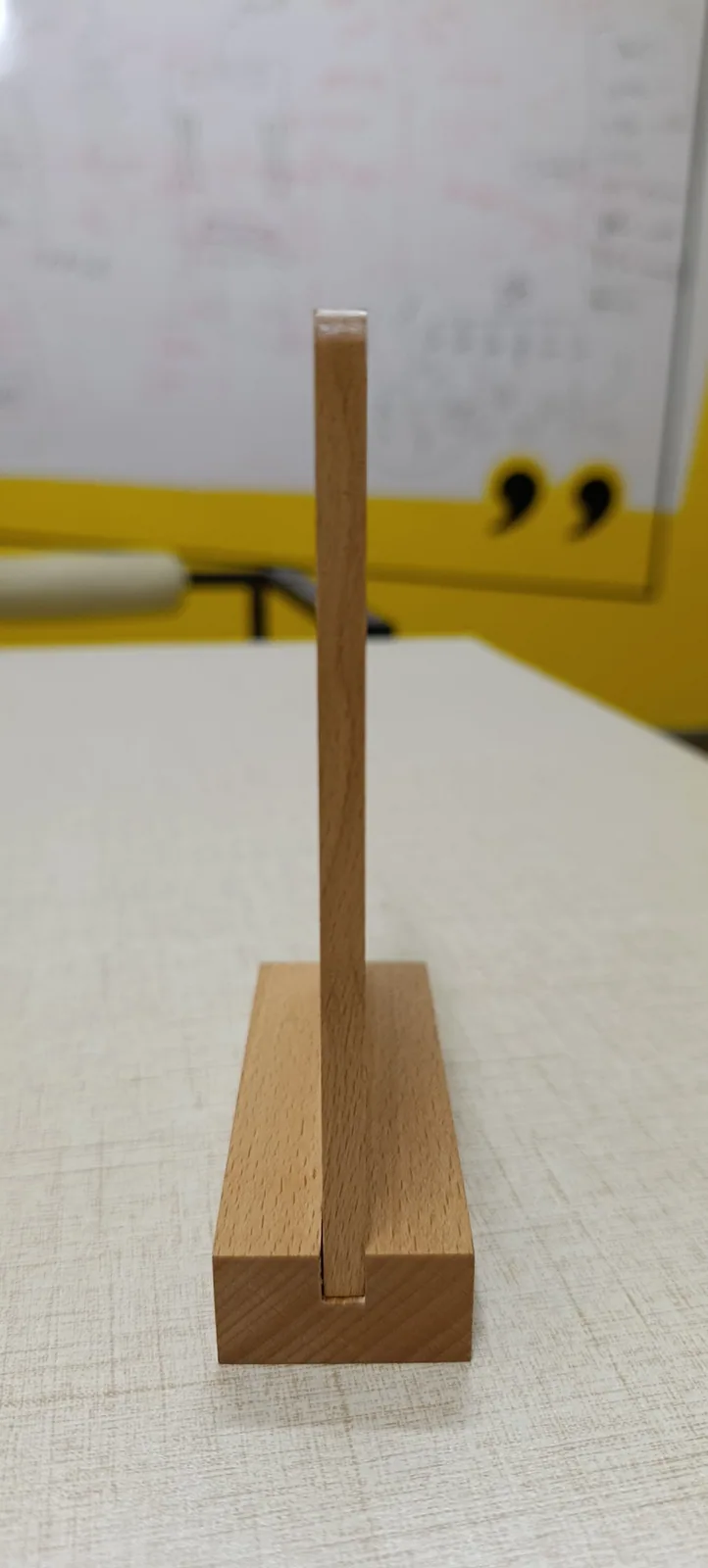 Side profile of the Review+ beechwood standee showing the slotted solid wooden base